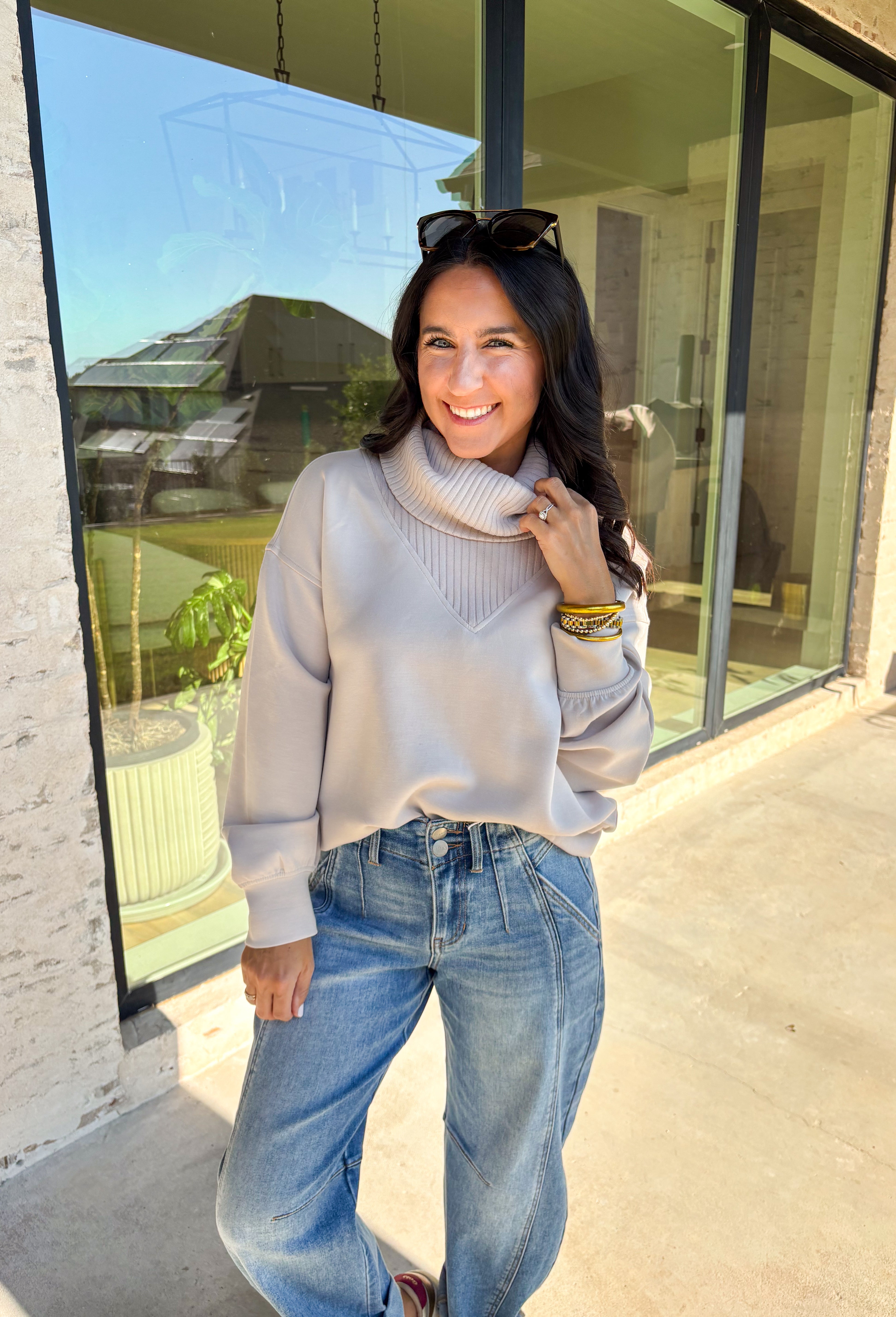 Classic and cozy, this neutral pullover is your new layering essential. The ribbed turtleneck design brings warmth and texture, while the soft modal-blend fabric keeps it comfortable with a hint of stretch. Long sleeves make it perfect for cooler weather, and the timeless silhouette pairs easily with jeans, skirts, or layered under jackets. Whether you’re heading out for errands or dressing it up for dinner, this pullover is a versatile go-to for the season.