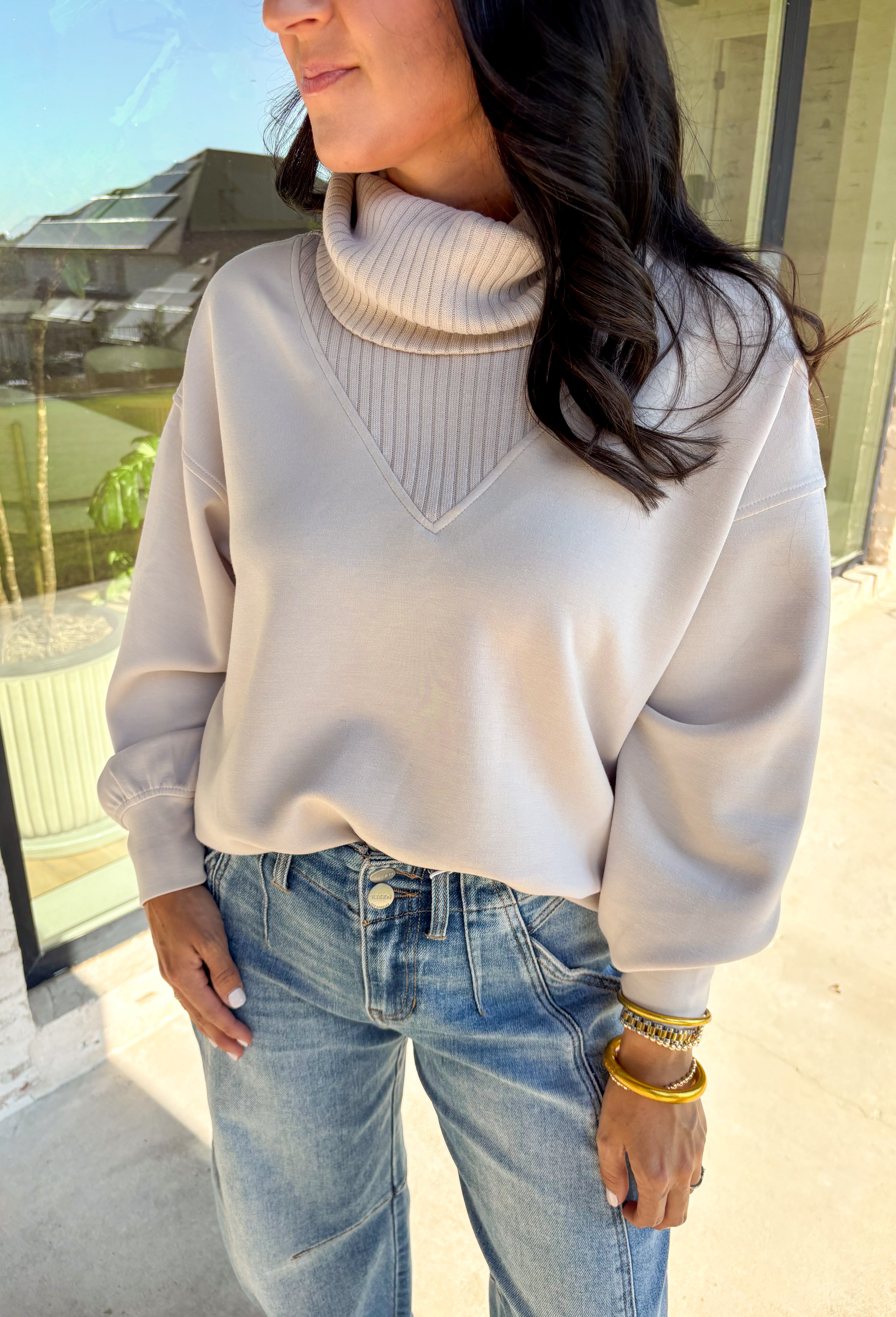 Classic and cozy, this neutral pullover is your new layering essential. The ribbed turtleneck design brings warmth and texture, while the soft modal-blend fabric keeps it comfortable with a hint of stretch. Long sleeves make it perfect for cooler weather, and the timeless silhouette pairs easily with jeans, skirts, or layered under jackets. Whether you’re heading out for errands or dressing it up for dinner, this pullover is a versatile go-to for the season.