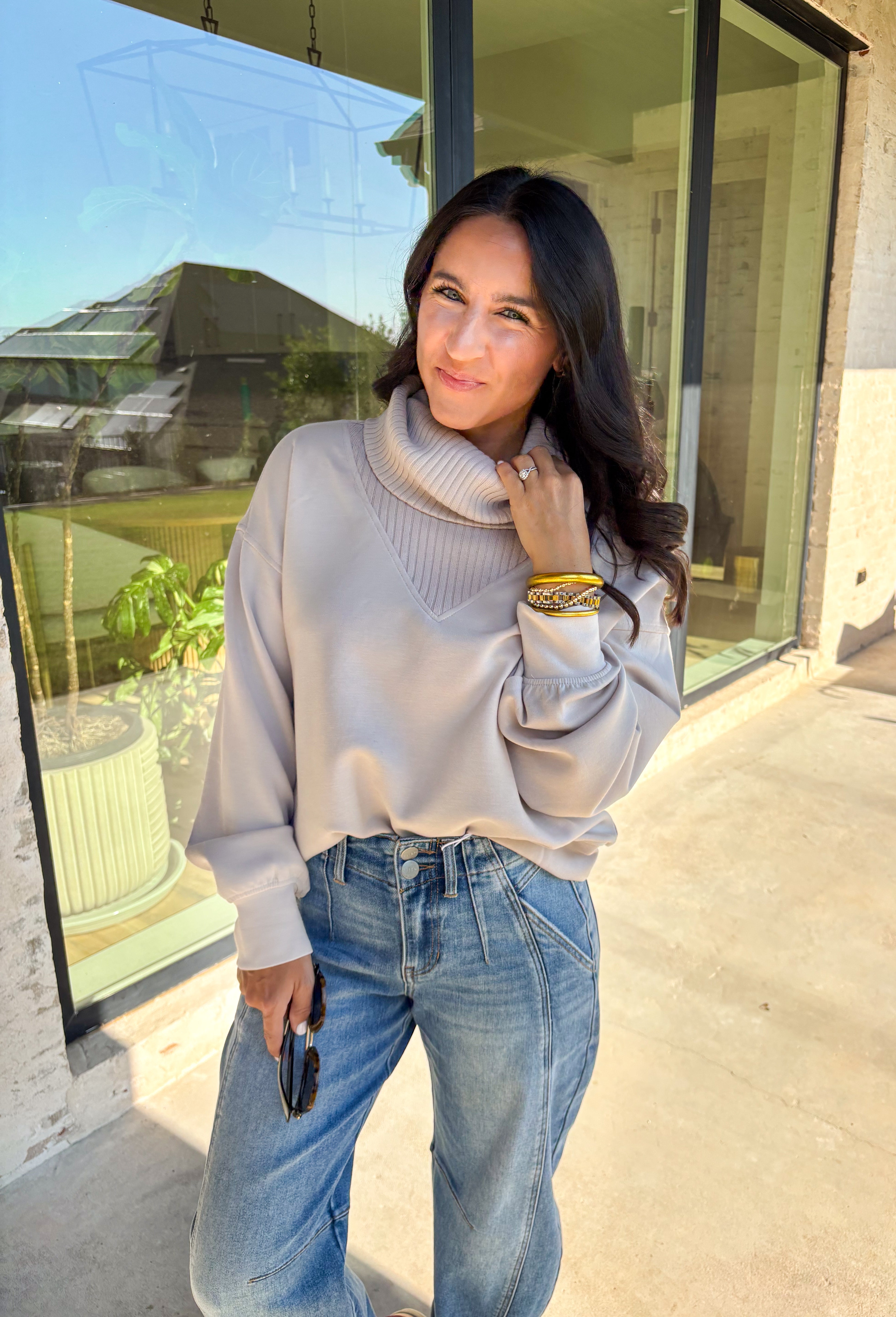 Classic and cozy, this neutral pullover is your new layering essential. The ribbed turtleneck design brings warmth and texture, while the soft modal-blend fabric keeps it comfortable with a hint of stretch. Long sleeves make it perfect for cooler weather, and the timeless silhouette pairs easily with jeans, skirts, or layered under jackets. Whether you’re heading out for errands or dressing it up for dinner, this pullover is a versatile go-to for the season.