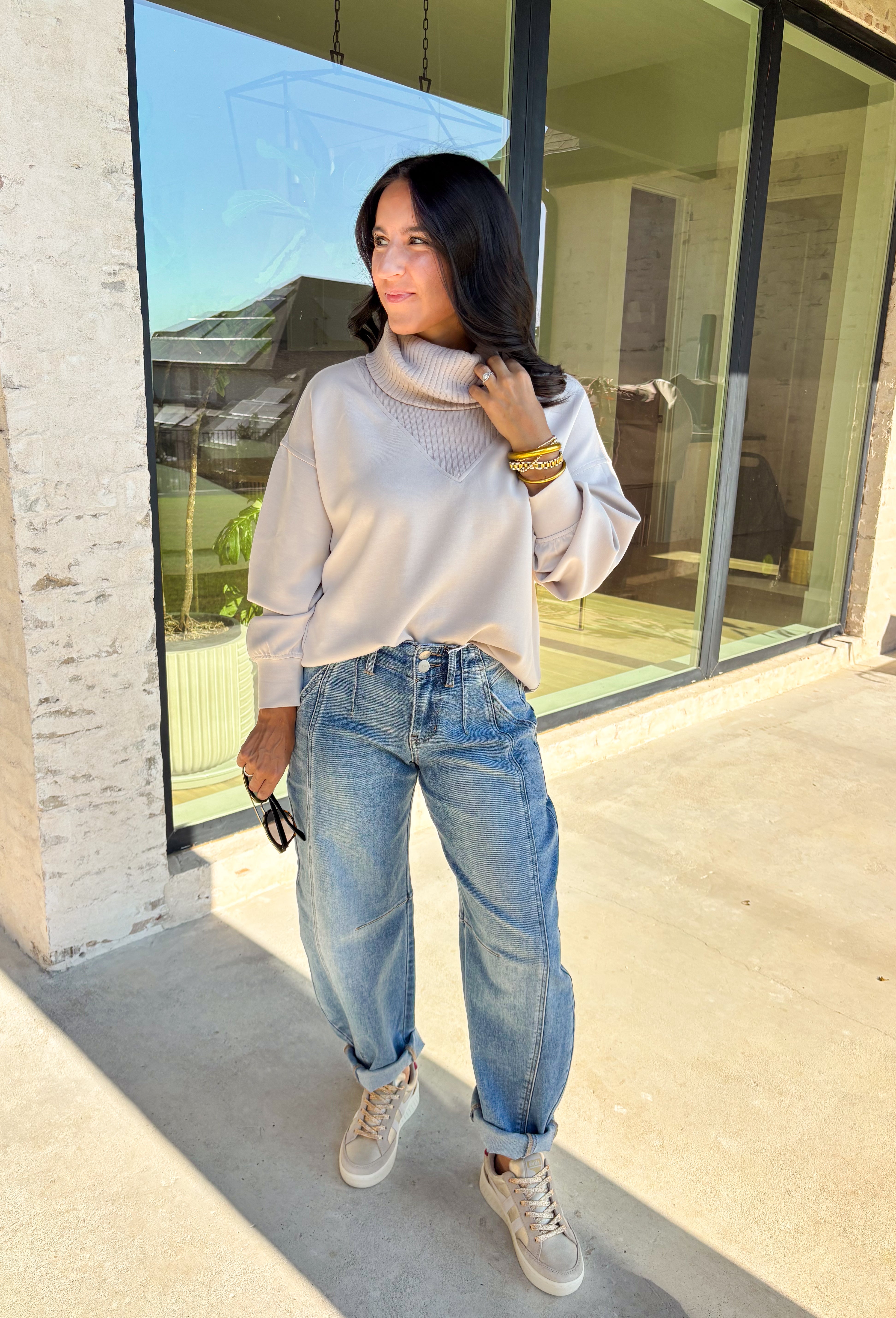 Classic and cozy, this neutral pullover is your new layering essential. The ribbed turtleneck design brings warmth and texture, while the soft modal-blend fabric keeps it comfortable with a hint of stretch. Long sleeves make it perfect for cooler weather, and the timeless silhouette pairs easily with jeans, skirts, or layered under jackets. Whether you’re heading out for errands or dressing it up for dinner, this pullover is a versatile go-to for the season.