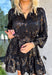 Bring a little shimmer to the season with this black long sleeve dress. Designed with a subtle leopard print in a textured, metallic-like finish, it adds depth and shine without being over the top. A button-down front and ruffle trim soften the look, making it equal parts chic and feminine. Lightweight yet lined, this dress is a perfect choice for special occasions, evening dinners, or holiday gatherings.