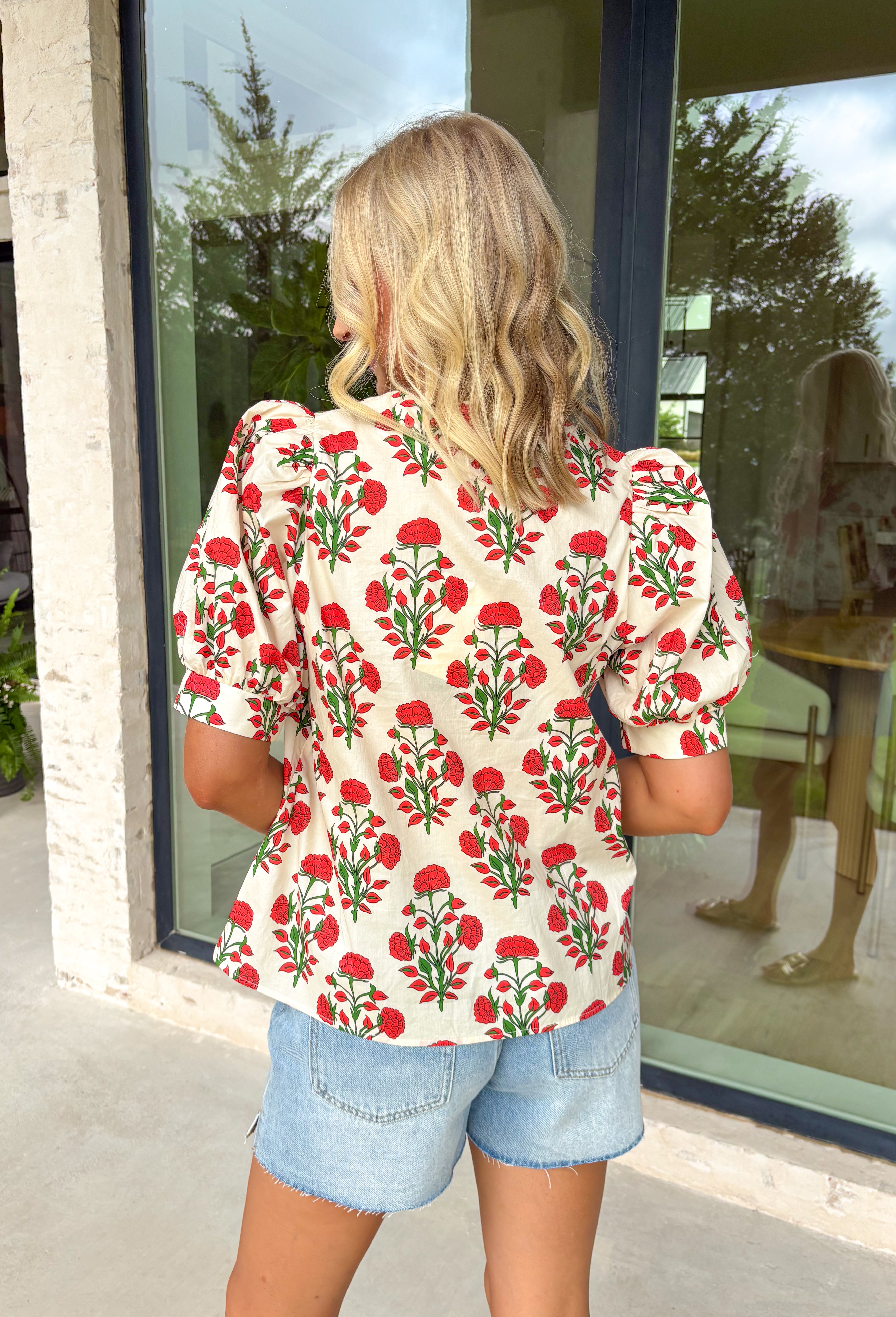 Easygoing with a touch of boho charm, this cream short sleeve top by Entro is perfect for laid-back spring days. Featuring a red floral print with fresh pops of green, it brings just the right amount of color to a neutral base. The macramé-style rope detailing along the top adds beautiful texture and a relaxed, artisan feel that makes this piece stand out while still being easy to wear. Lightweight cotton keeps it comfortable and breathable all season long.