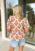 Easygoing with a touch of boho charm, this cream short sleeve top by Entro is perfect for laid-back spring days. Featuring a red floral print with fresh pops of green, it brings just the right amount of color to a neutral base. The macramé-style rope detailing along the top adds beautiful texture and a relaxed, artisan feel that makes this piece stand out while still being easy to wear. Lightweight cotton keeps it comfortable and breathable all season long.