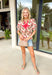 Easygoing with a touch of boho charm, this cream short sleeve top by Entro is perfect for laid-back spring days. Featuring a red floral print with fresh pops of green, it brings just the right amount of color to a neutral base. The macramé-style rope detailing along the top adds beautiful texture and a relaxed, artisan feel that makes this piece stand out while still being easy to wear. Lightweight cotton keeps it comfortable and breathable all season long.