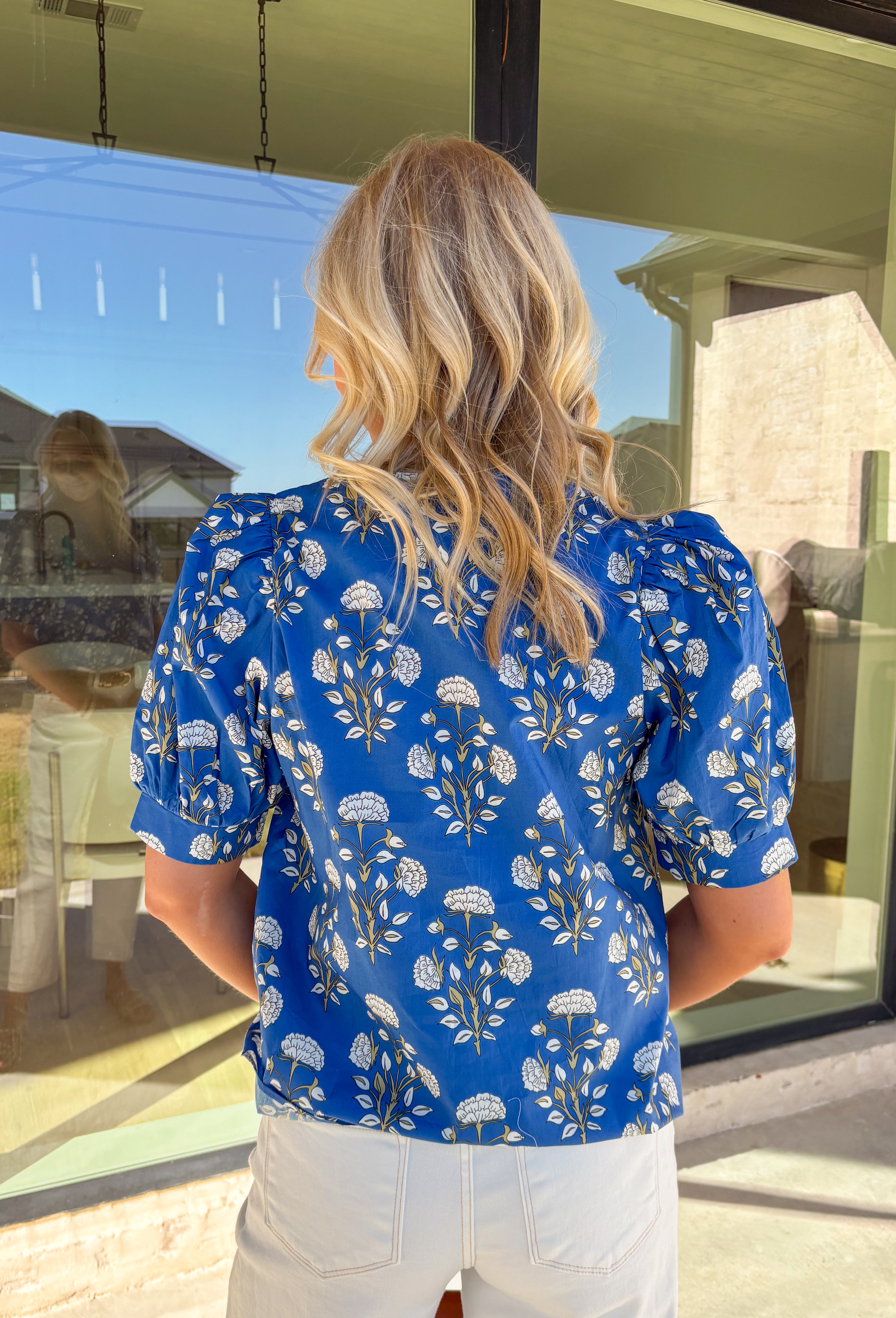 Easygoing with a touch of boho charm, this blue short sleeve top by Entro is perfect for laid-back spring days. Featuring a floral print with fresh pops of green, it is the perfect spring top. The macramé-style rope detailing along the top adds beautiful texture and a relaxed, artisan feel that makes this piece stand out while still being easy to wear. Lightweight cotton keeps it comfortable and breathable all season long.