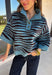 A dusty blue background gives this cozy knit sweater from Entro a fresh pop of color for the season. The darker abstract animal print creates a bold contrast against the dusty blue shade, adding plenty of personality without being difficult to style. A stand neckline and partial button-front closure bring a classic touch to the relaxed knit silhouette, while the ¾ sleeves make it a great option for transitional weather. 