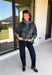 A dusty blue background gives this cozy knit sweater from Entro a fresh pop of color for the season. The darker abstract animal print creates a bold contrast against the dusty blue shade, adding plenty of personality without being difficult to style. A stand neckline and partial button-front closure bring a classic touch to the relaxed knit silhouette, while the ¾ sleeves make it a great option for transitional weather. 