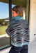 A dusty blue background gives this cozy knit sweater from Entro a fresh pop of color for the season. The darker abstract animal print creates a bold contrast against the dusty blue shade, adding plenty of personality without being difficult to style. A stand neckline and partial button-front closure bring a classic touch to the relaxed knit silhouette, while the ¾ sleeves make it a great option for transitional weather. 