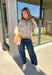 A neutral animal print gives this cozy knit top from Entro plenty of personality while keeping it easy to mix into your fall wardrobe. The abstract pattern brings together versatile neutral shades for a fresh take on a classic animal print. A stand neckline and partial button-front closure add structure to the relaxed knit silhouette, while the ¾ sleeves make it a great choice for those in-between weather days. 