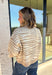 A neutral animal print gives this cozy knit top from Entro plenty of personality while keeping it easy to mix into your fall wardrobe. The abstract pattern brings together versatile neutral shades for a fresh take on a classic animal print. A stand neckline and partial button-front closure add structure to the relaxed knit silhouette, while the ¾ sleeves make it a great choice for those in-between weather days. 