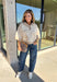 A neutral animal print gives this cozy knit top from Entro plenty of personality while keeping it easy to mix into your fall wardrobe. The abstract pattern brings together versatile neutral shades for a fresh take on a classic animal print. A stand neckline and partial button-front closure add structure to the relaxed knit silhouette, while the ¾ sleeves make it a great choice for those in-between weather days. 