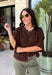 Cozy, classic, and endlessly versatile, this button-down cardigan from Double Zero is the perfect layering piece for the season. Designed in a rich dark brown hue, this soft knit cardigan is easy to style with everything from denim to dresses. The ribbed neckline adds a timeless touch, while the cozy knit construction keeps you comfortable throughout the day. Wear it buttoned as a sweater or open over your favorite basics for an effortlessly polished fall look.