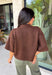 Cozy, classic, and endlessly versatile, this button-down cardigan from Double Zero is the perfect layering piece for the season. Designed in a rich dark brown hue, this soft knit cardigan is easy to style with everything from denim to dresses. The ribbed neckline adds a timeless touch, while the cozy knit construction keeps you comfortable throughout the day. Wear it buttoned as a sweater or open over your favorite basics for an effortlessly polished fall look.