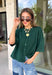 Cozy, classic, and endlessly versatile, this button-down cardigan from Double Zero is the perfect layering piece for the season. Designed in a rich dark green hue, this soft knit cardigan is easy to style with everything from denim to dresses. The ribbed neckline adds a timeless touch, while the cozy knit construction keeps you comfortable throughout the day. Wear it buttoned as a sweater or open over your favorite basics for an effortlessly polished fall look.