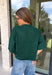 Cozy, classic, and endlessly versatile, this button-down cardigan from Double Zero is the perfect layering piece for the season. Designed in a rich dark green hue, this soft knit cardigan is easy to style with everything from denim to dresses. The ribbed neckline adds a timeless touch, while the cozy knit construction keeps you comfortable throughout the day. Wear it buttoned as a sweater or open over your favorite basics for an effortlessly polished fall look.