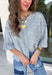 Cozy, classic, and endlessly versatile, this button-down cardigan from Double Zero is the perfect layering piece for the season. Designed in a heather grey hue, this soft knit cardigan is easy to style with everything from denim to dresses. The ribbed neckline adds a timeless touch, while the cozy knit construction keeps you comfortable throughout the day. Wear it buttoned as a sweater or open over your favorite basics for an effortlessly polished fall look.