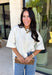 Cozy, classic, and endlessly versatile, this button-down cardigan from Double Zero is the perfect layering piece for the season. Designed in a neutral whip cream hue, this soft knit cardigan is easy to style with everything from denim to dresses. The ribbed neckline adds a timeless touch, while the cozy knit construction keeps you comfortable throughout the day. Wear it buttoned as a sweater or open over your favorite basics for an effortlessly polished fall look.