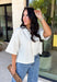 Cozy, classic, and endlessly versatile, this button-down cardigan from Double Zero is the perfect layering piece for the season. Designed in a neutral whip cream hue, this soft knit cardigan is easy to style with everything from denim to dresses. The ribbed neckline adds a timeless touch, while the cozy knit construction keeps you comfortable throughout the day. Wear it buttoned as a sweater or open over your favorite basics for an effortlessly polished fall look.