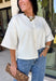 Cozy, classic, and endlessly versatile, this button-down cardigan from Double Zero is the perfect layering piece for the season. Designed in a neutral whip cream hue, this soft knit cardigan is easy to style with everything from denim to dresses. The ribbed neckline adds a timeless touch, while the cozy knit construction keeps you comfortable throughout the day. Wear it buttoned as a sweater or open over your favorite basics for an effortlessly polished fall look.