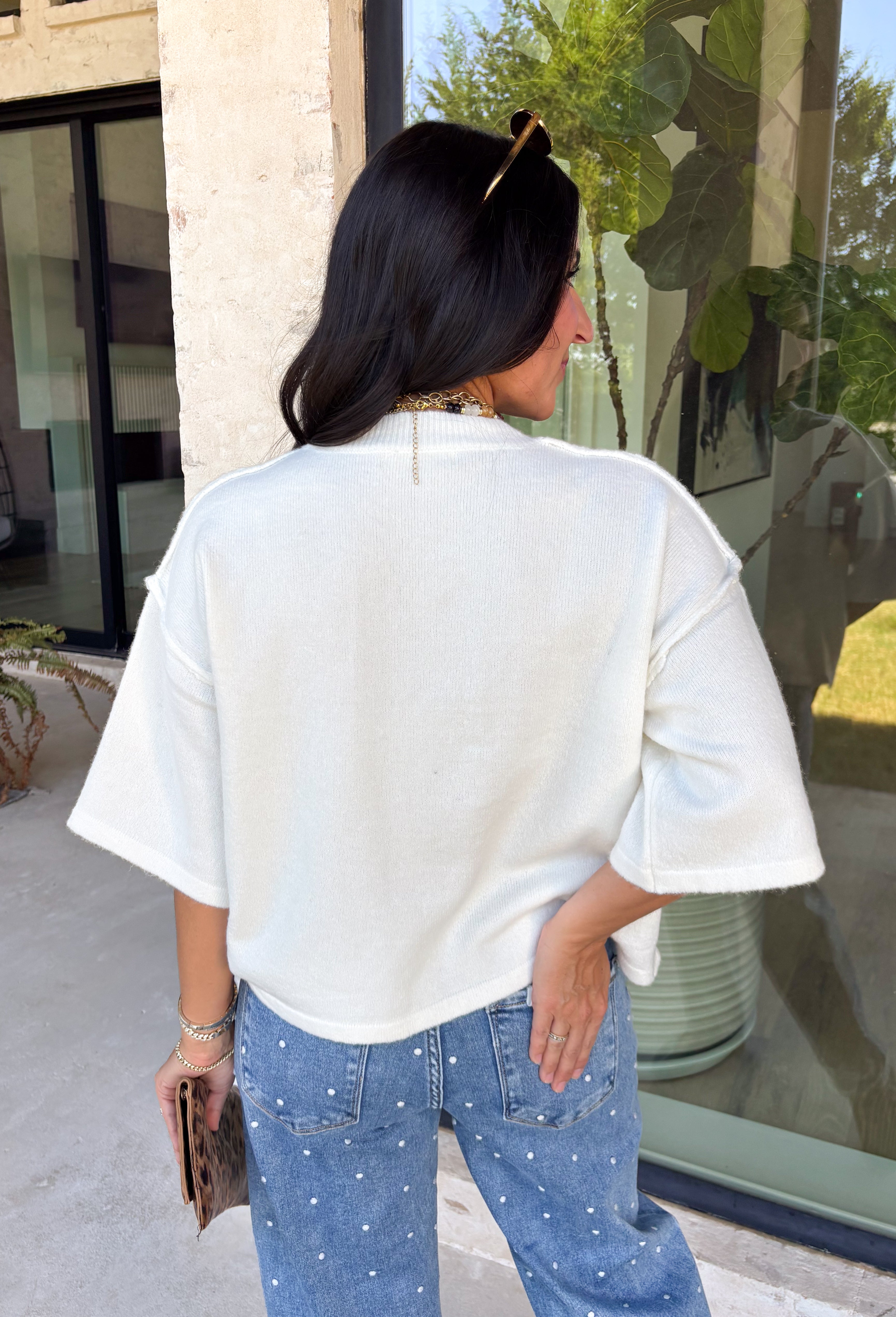 Cozy, classic, and endlessly versatile, this button-down cardigan from Double Zero is the perfect layering piece for the season. Designed in a neutral whip cream hue, this soft knit cardigan is easy to style with everything from denim to dresses. The ribbed neckline adds a timeless touch, while the cozy knit construction keeps you comfortable throughout the day. Wear it buttoned as a sweater or open over your favorite basics for an effortlessly polished fall look.
