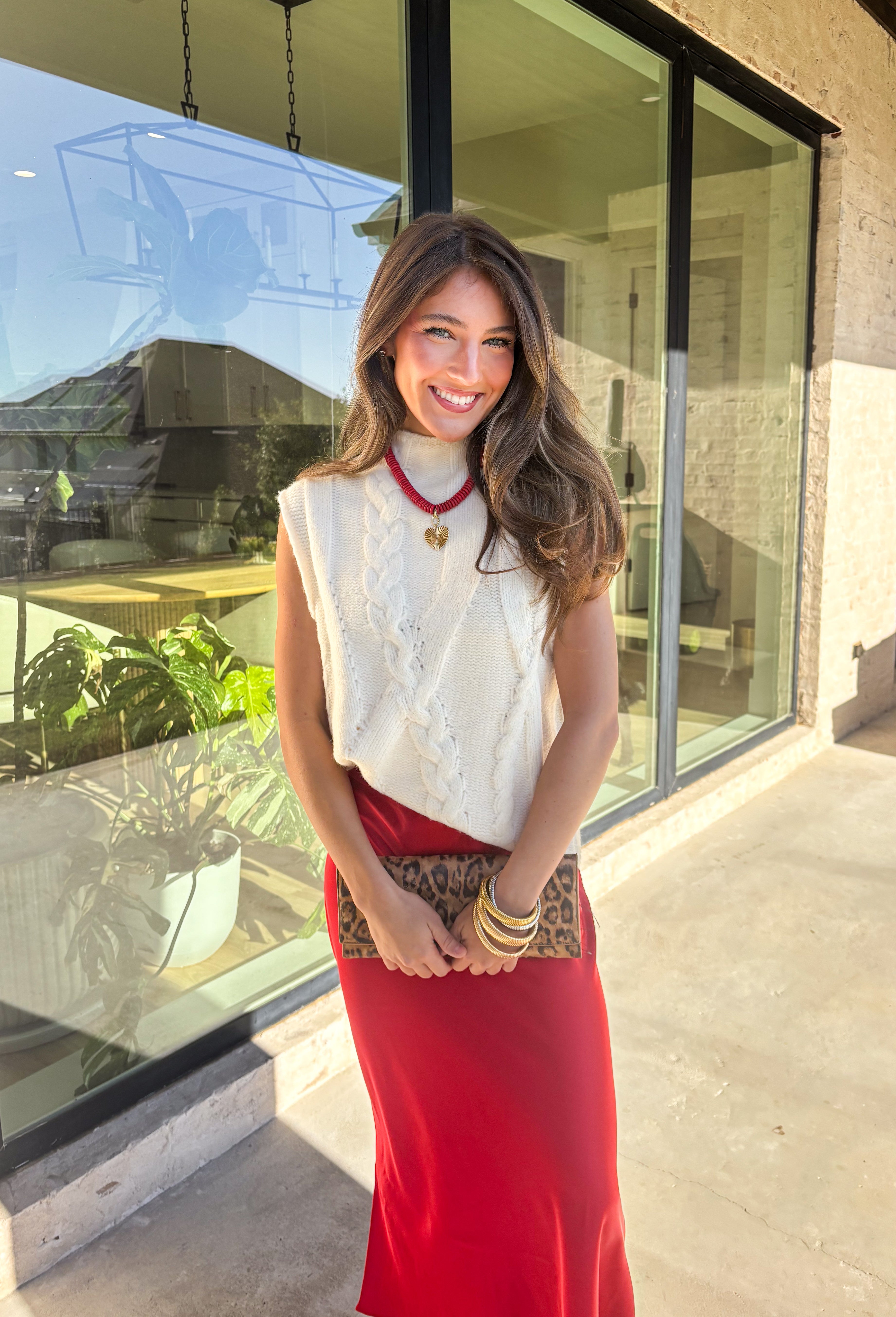 This cream cable knit sweater is the layering piece your fall wardrobe has been waiting for. Designed sleeveless with a mock neckline, it’s both versatile and cozy, making it easy to wear on its own or styled over your favorite blouses. The chunky knit texture adds timeless appeal, while the neutral cream tone keeps it a go-to for any outfit. Lightweight yet warm, it’s a perfect match for transitional days that call for comfort with style.