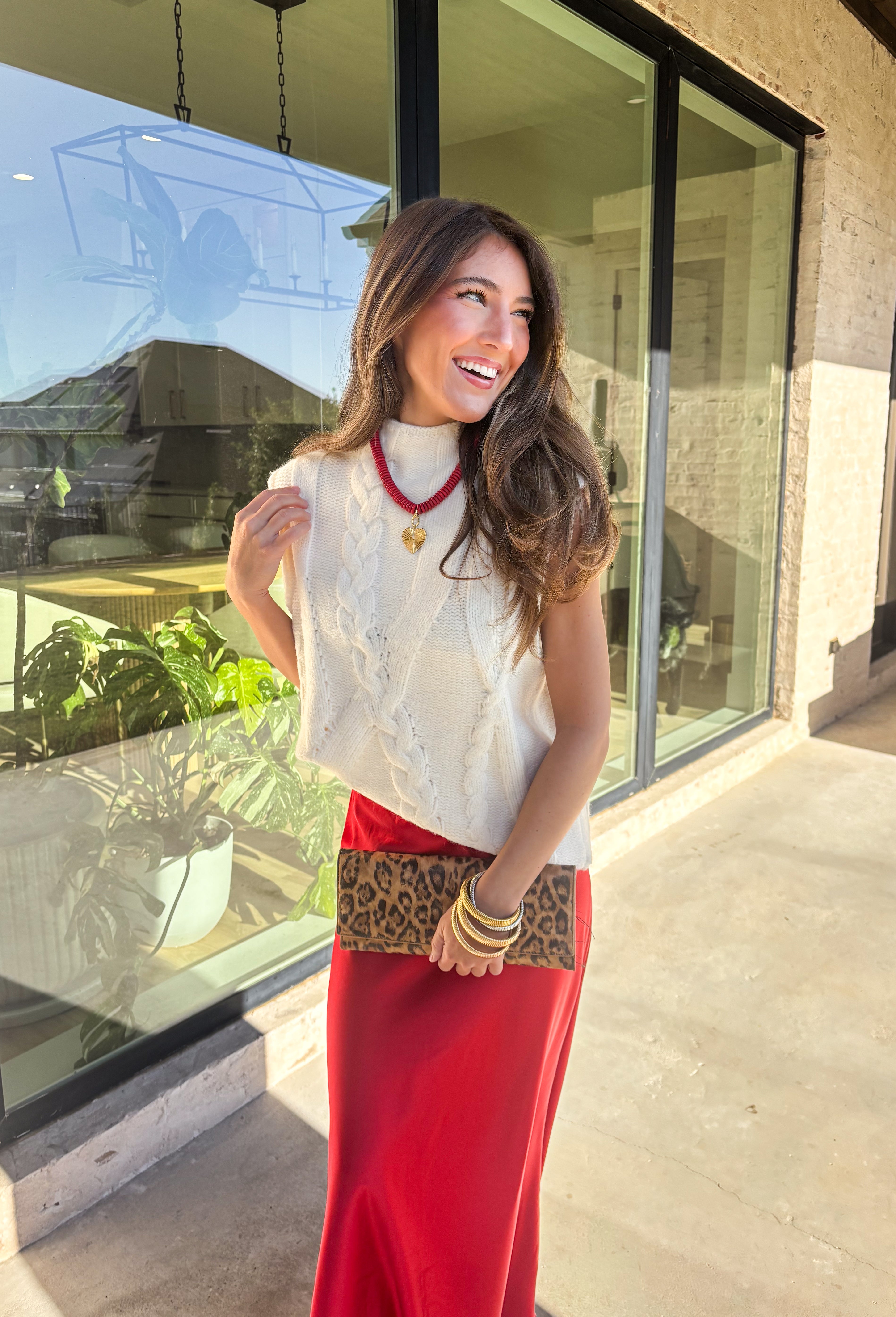 This cream cable knit sweater is the layering piece your fall wardrobe has been waiting for. Designed sleeveless with a mock neckline, it’s both versatile and cozy, making it easy to wear on its own or styled over your favorite blouses. The chunky knit texture adds timeless appeal, while the neutral cream tone keeps it a go-to for any outfit. Lightweight yet warm, it’s a perfect match for transitional days that call for comfort with style.