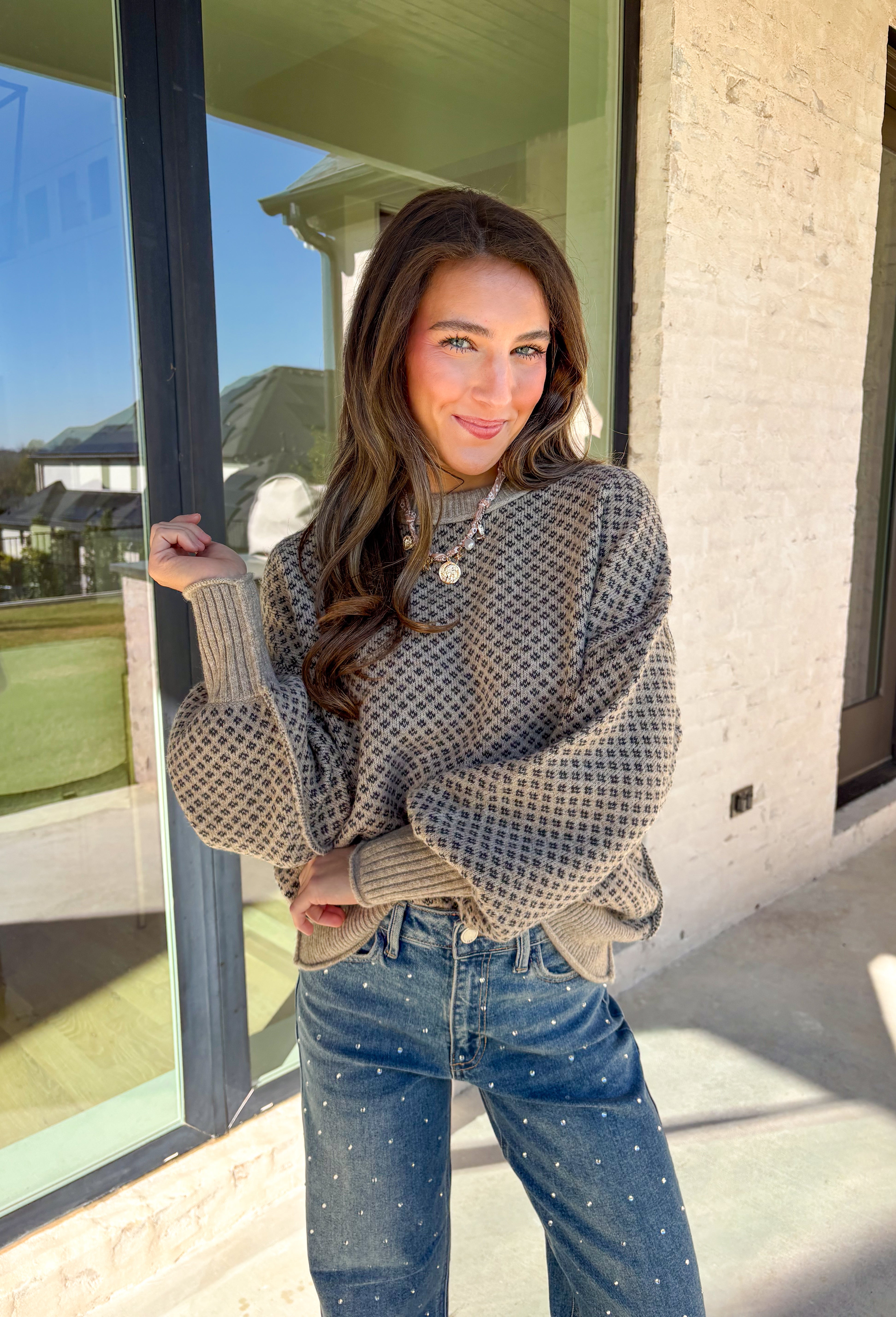 Stay warm and effortlessly stylish in this khaki sweater by Blu Pepper. Designed with a tiny charcoal geometric print throughout, this cozy knit brings just the right amount of pattern while keeping things neutral and easy to pair. Soft, warm, and perfect for chilly days, it’s an instant winter staple you’ll reach for again and again.