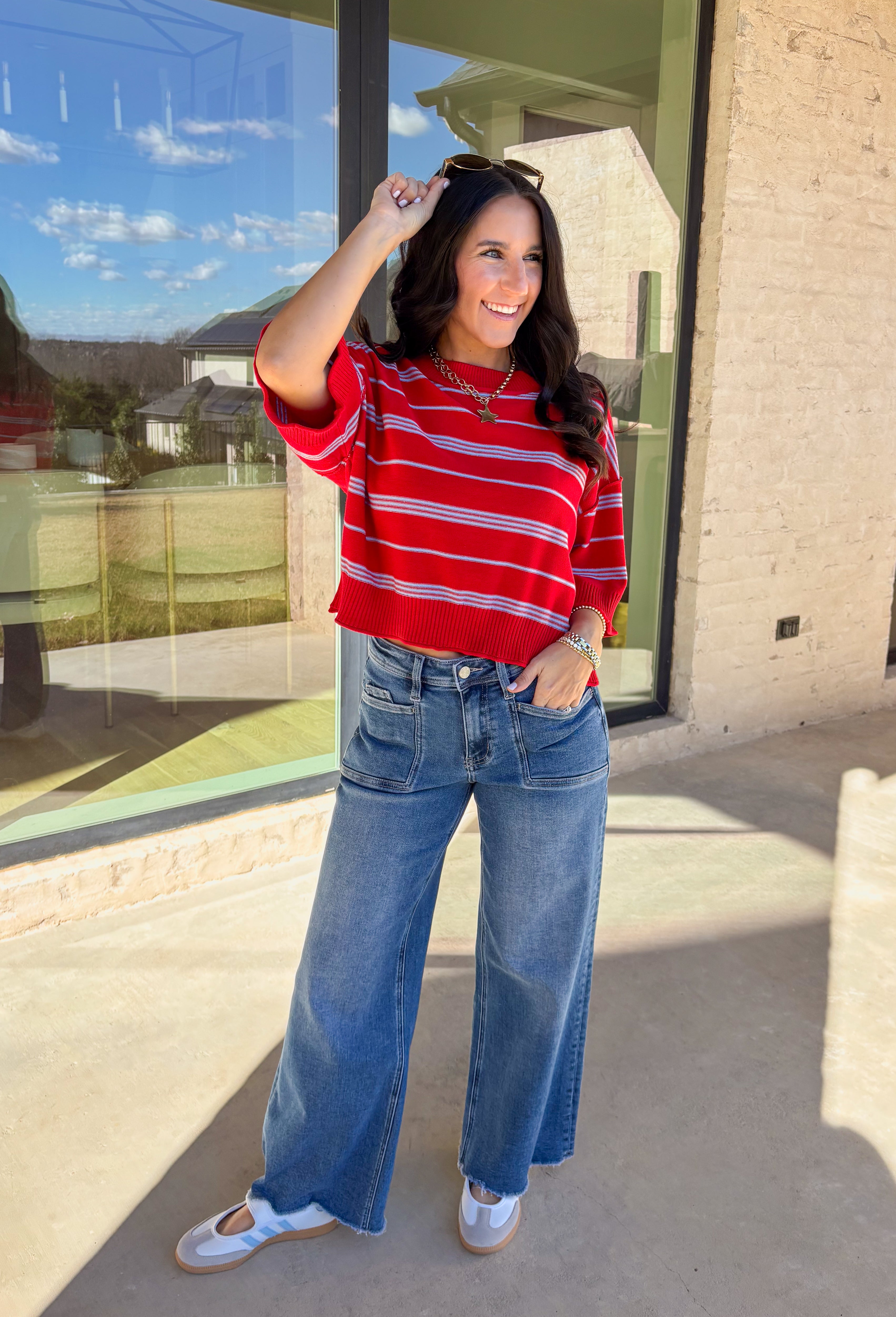 Bold, breezy, and perfect for spring layering, this striped knit top by Entro brings an easy pop of color to your everyday look. Featuring red and light blue stripes with a relaxed drop shoulder fit, it feels laid-back yet polished. The ribbed neckline, cuffs, and hem add subtle structure, while the cropped length keeps it fun and on-trend. Lightweight and comfortable, it’s an easy piece to style all season long.