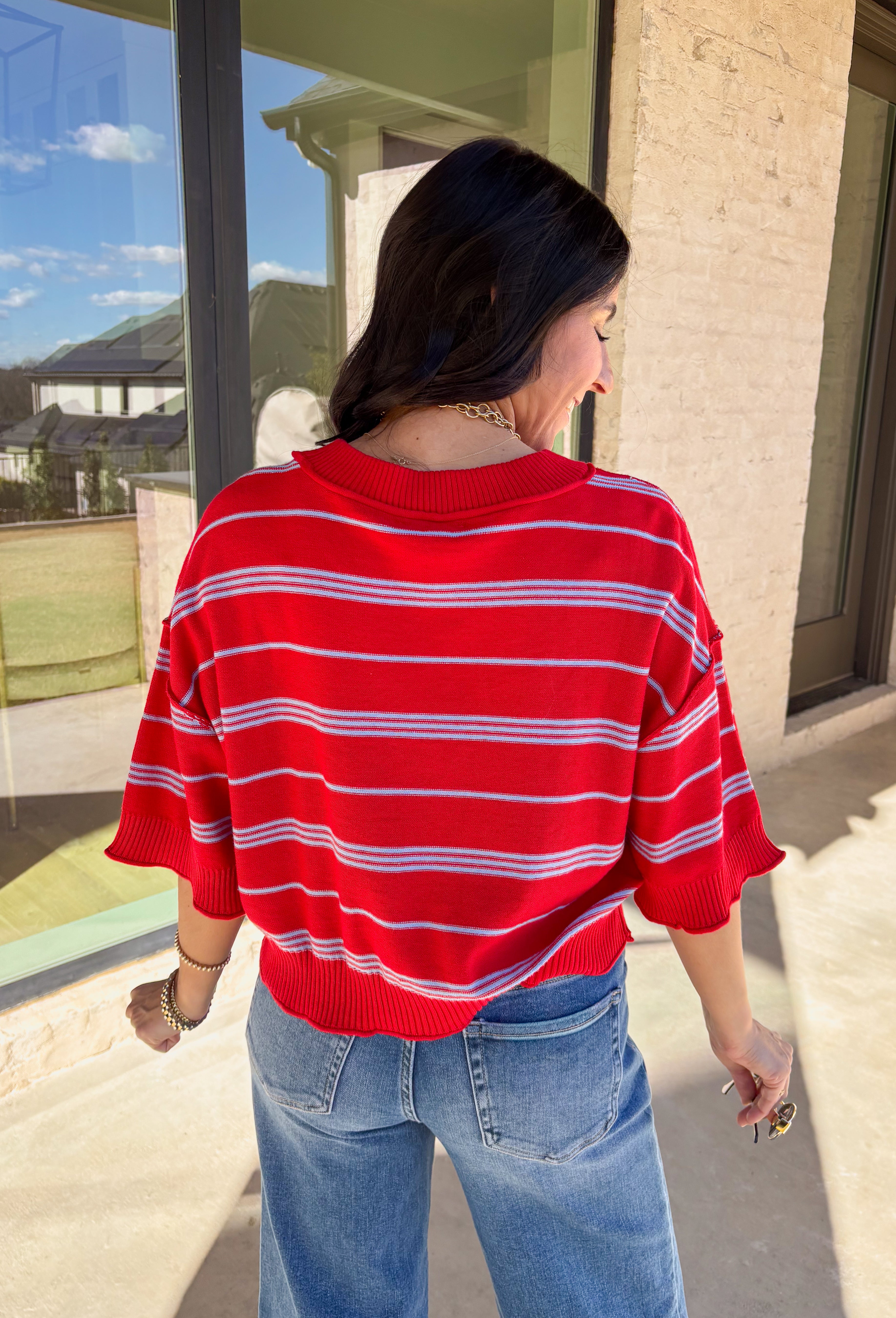 Bold, breezy, and perfect for spring layering, this striped knit top by Entro brings an easy pop of color to your everyday look. Featuring red and light blue stripes with a relaxed drop shoulder fit, it feels laid-back yet polished. The ribbed neckline, cuffs, and hem add subtle structure, while the cropped length keeps it fun and on-trend. Lightweight and comfortable, it’s an easy piece to style all season long.