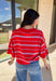 Bold, breezy, and perfect for spring layering, this striped knit top by Entro brings an easy pop of color to your everyday look. Featuring red and light blue stripes with a relaxed drop shoulder fit, it feels laid-back yet polished. The ribbed neckline, cuffs, and hem add subtle structure, while the cropped length keeps it fun and on-trend. Lightweight and comfortable, it’s an easy piece to style all season long.