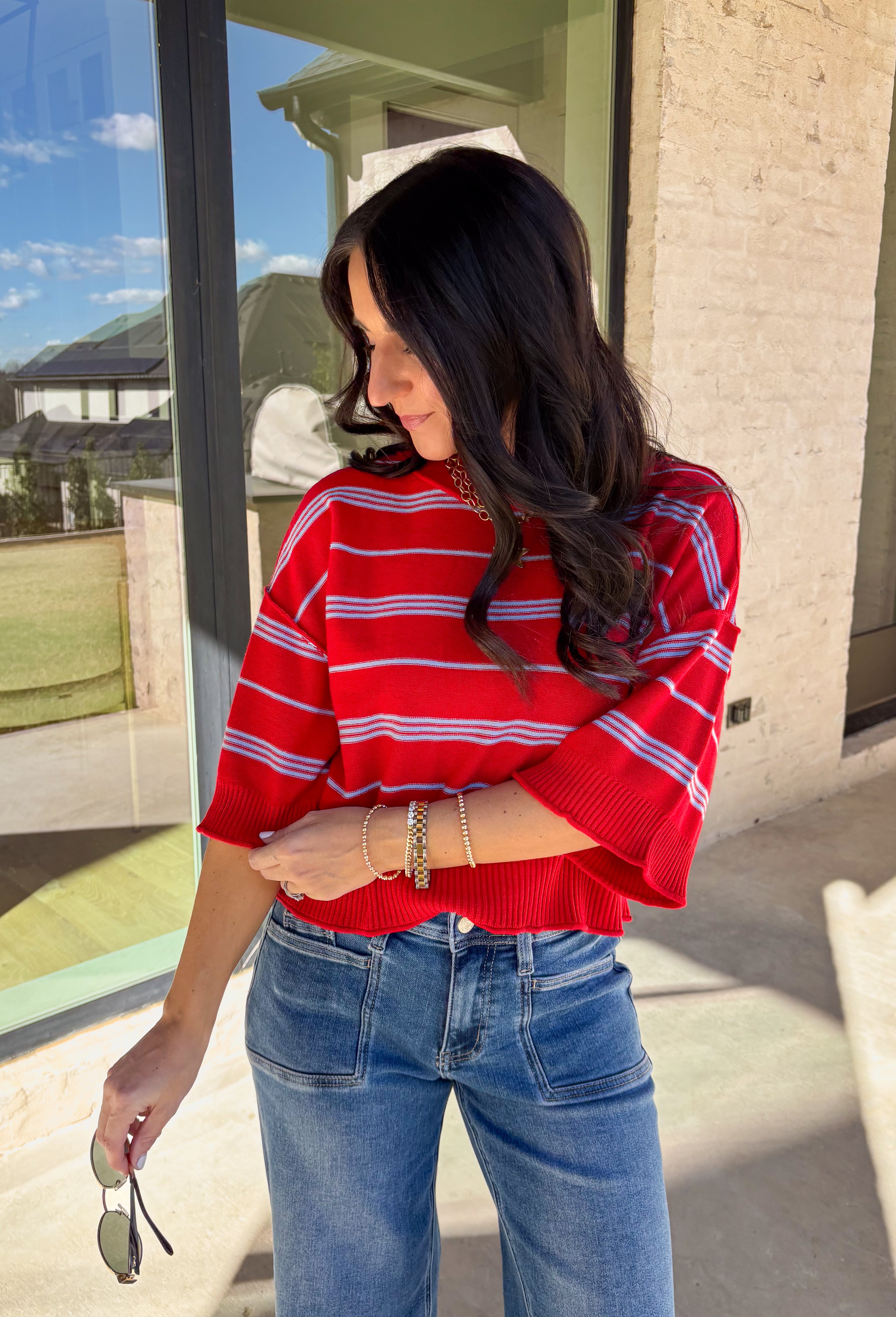 Bold, breezy, and perfect for spring layering, this striped knit top by Entro brings an easy pop of color to your everyday look. Featuring red and light blue stripes with a relaxed drop shoulder fit, it feels laid-back yet polished. The ribbed neckline, cuffs, and hem add subtle structure, while the cropped length keeps it fun and on-trend. Lightweight and comfortable, it’s an easy piece to style all season long.