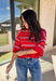 Bold, breezy, and perfect for spring layering, this striped knit top by Entro brings an easy pop of color to your everyday look. Featuring red and light blue stripes with a relaxed drop shoulder fit, it feels laid-back yet polished. The ribbed neckline, cuffs, and hem add subtle structure, while the cropped length keeps it fun and on-trend. Lightweight and comfortable, it’s an easy piece to style all season long.