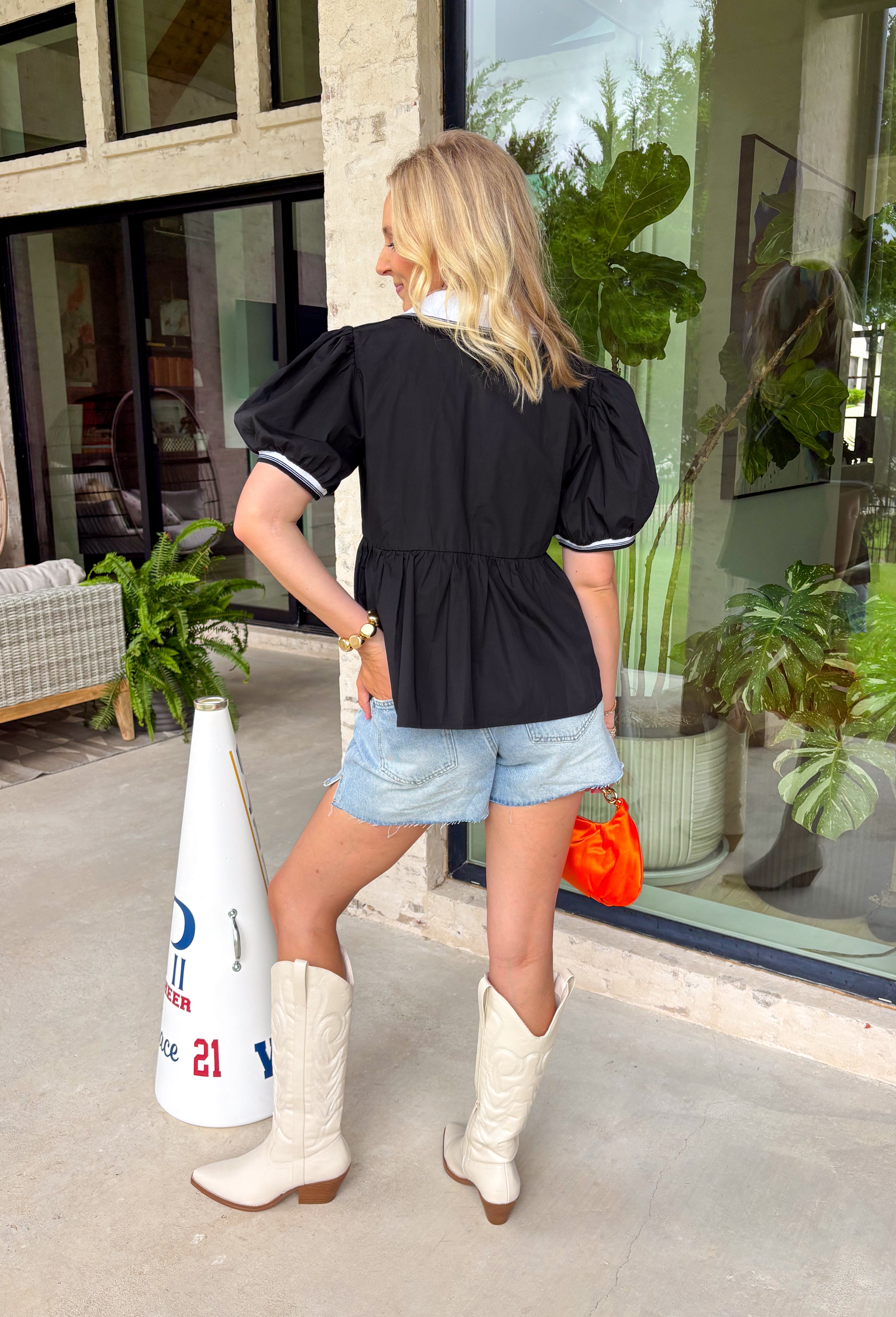 This black babydoll top is the perfect blend of playful and polished for the fall season! The black color is classic, while the crisp white contrast trim along the collar, front, and sleeves adds a classic touch that never goes out of style. Puff sleeves and the relaxed babydoll silhouette create an easy, flattering fit you'll love for busy days and weekend plans alike. Made from breathable cotton, it's comfortable enough for all-day wear and easy to layer.