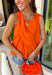 This orange sleeveless top is the versatile staple your wardrobe needs all year long! The vibrant color makes it a standout choice for game day season, while the clean, classic silhouette ensures you'll wear it far beyond football weekends. Designed with a high round neckline and a simple keyhole button closure in the back, it has an elevated look that's easy to dress up or down.