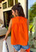 This orange sleeveless top is the versatile staple your wardrobe needs all year long! The vibrant color makes it a standout choice for game day season, while the clean, classic silhouette ensures you'll wear it far beyond football weekends. Designed with a high round neckline and a simple keyhole button closure in the back, it has an elevated look that's easy to dress up or down.