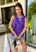 This purple sleeveless top is the versatile staple your wardrobe needs all year long! The vibrant color makes it a standout choice for game day season, while the clean, classic silhouette ensures you'll wear it far beyond football weekends. Designed with a high round neckline and a simple keyhole button closure in the back, it has an elevated look that's easy to dress up or down. 