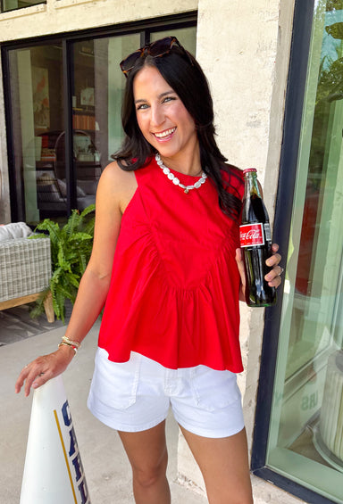 This red sleeveless top is the versatile staple your wardrobe needs all year long! The vibrant color makes it a standout choice for game day season, while the clean, classic silhouette ensures you'll wear it far beyond football weekends. Designed with a high round neckline and a simple keyhole button closure in the back, it has an elevated look that's easy to dress up or down.