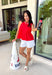 This red sleeveless top is the versatile staple your wardrobe needs all year long! The vibrant color makes it a standout choice for game day season, while the clean, classic silhouette ensures you'll wear it far beyond football weekends. Designed with a high round neckline and a simple keyhole button closure in the back, it has an elevated look that's easy to dress up or down.