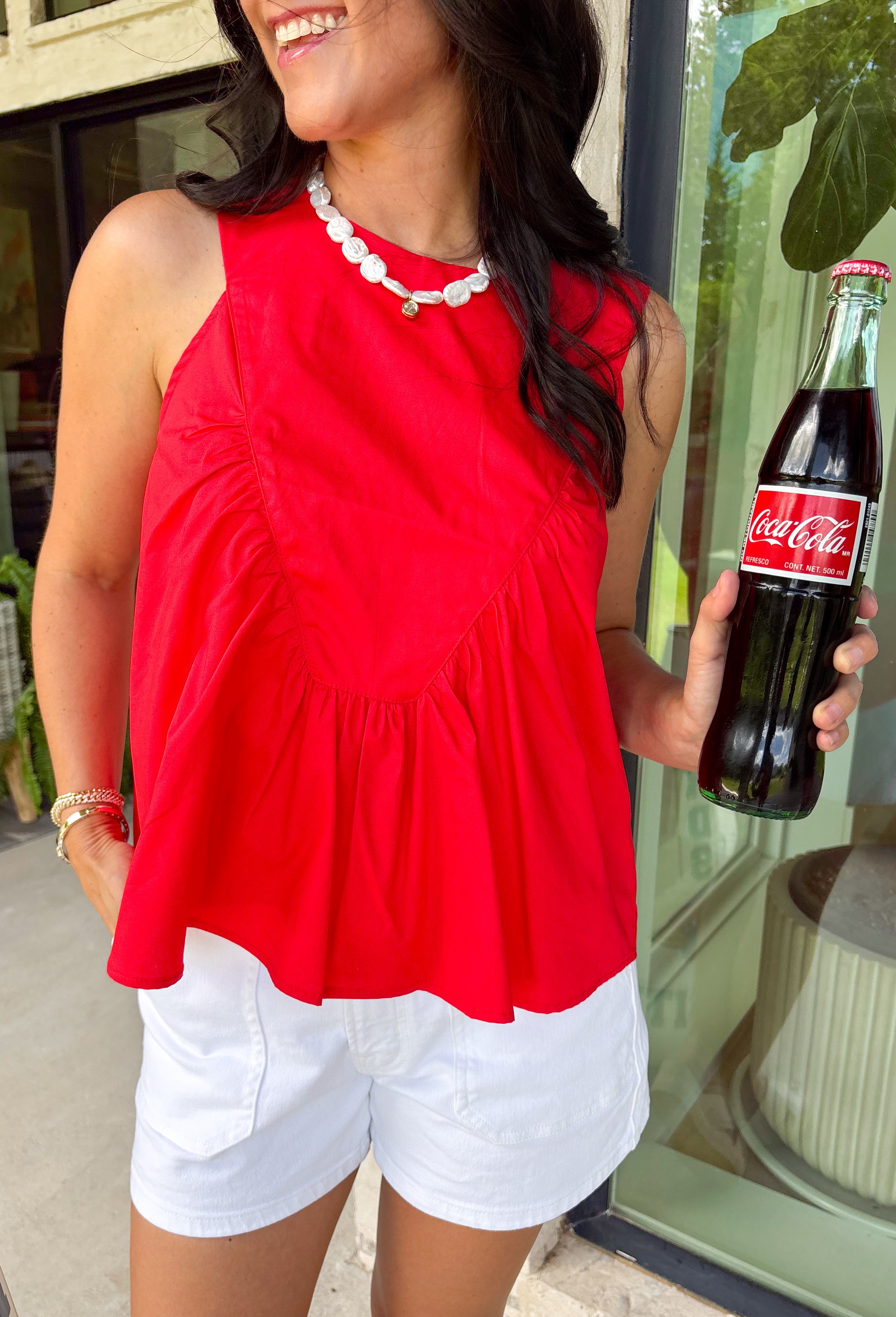 This red sleeveless top is the versatile staple your wardrobe needs all year long! The vibrant color makes it a standout choice for game day season, while the clean, classic silhouette ensures you'll wear it far beyond football weekends. Designed with a high round neckline and a simple keyhole button closure in the back, it has an elevated look that's easy to dress up or down.