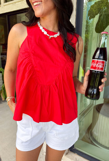 This red sleeveless top is the versatile staple your wardrobe needs all year long! The vibrant color makes it a standout choice for game day season, while the clean, classic silhouette ensures you'll wear it far beyond football weekends. Designed with a high round neckline and a simple keyhole button closure in the back, it has an elevated look that's easy to dress up or down.