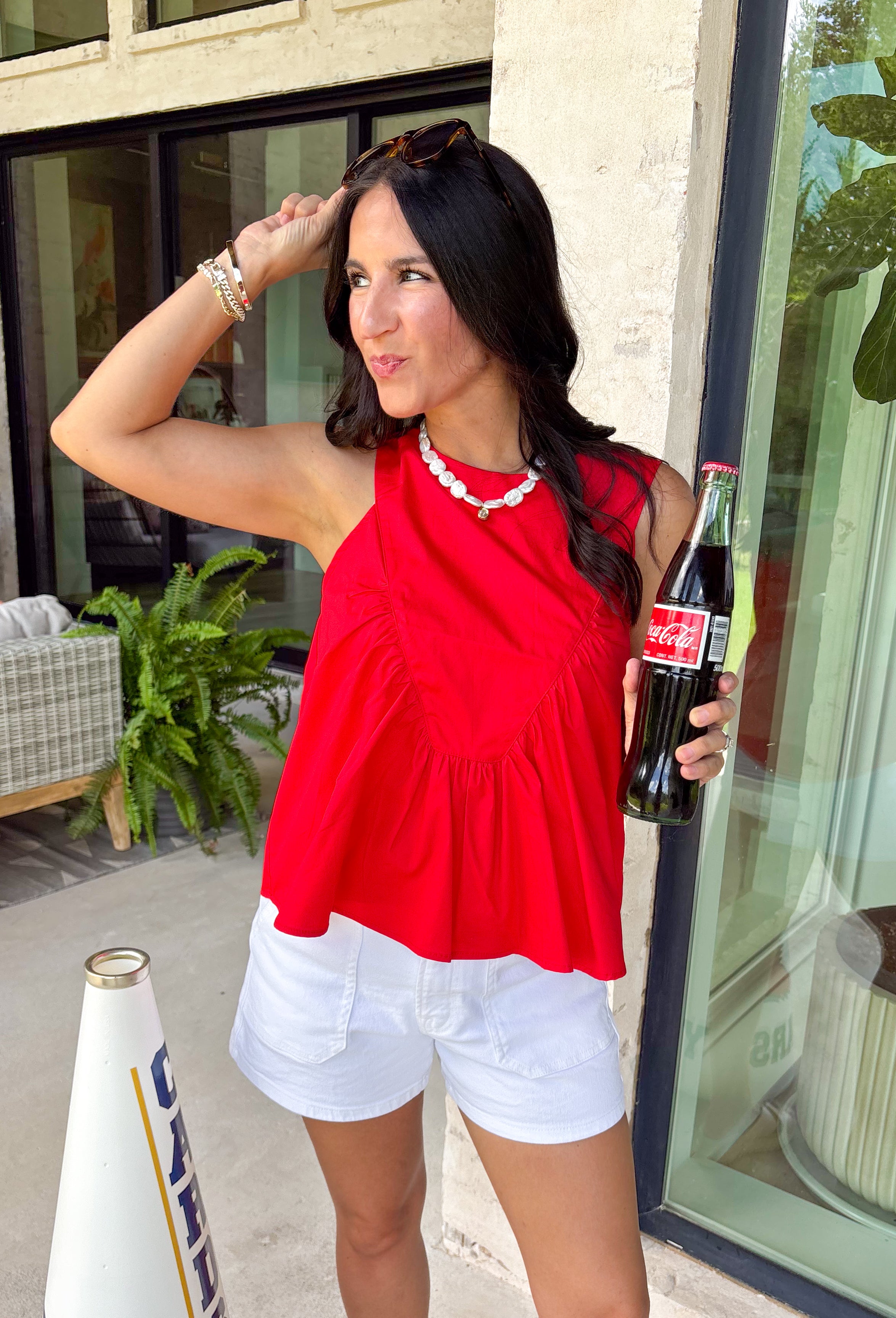 This red sleeveless top is the versatile staple your wardrobe needs all year long! The vibrant color makes it a standout choice for game day season, while the clean, classic silhouette ensures you'll wear it far beyond football weekends. Designed with a high round neckline and a simple keyhole button closure in the back, it has an elevated look that's easy to dress up or down.