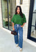 Add a playful pop of color to your fall wardrobe with this cozy short sleeve sweater! Featuring a rich pine green knit with soft pink contrast trim, this sweater is the perfect mix of timeless and fun. The ribbed detailing along the neckline, sleeves, and hem adds a classic finishing touch, while the lightweight knit keeps it comfortable for layering throughout the season. 
