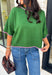 Add a playful pop of color to your fall wardrobe with this cozy short sleeve sweater! Featuring a rich pine green knit with soft pink contrast trim, this sweater is the perfect mix of timeless and fun. The ribbed detailing along the neckline, sleeves, and hem adds a classic finishing touch, while the lightweight knit keeps it comfortable for layering throughout the season. 