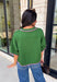Add a playful pop of color to your fall wardrobe with this cozy short sleeve sweater! Featuring a rich pine green knit with soft pink contrast trim, this sweater is the perfect mix of timeless and fun. The ribbed detailing along the neckline, sleeves, and hem adds a classic finishing touch, while the lightweight knit keeps it comfortable for layering throughout the season. 