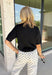A timeless black sweater is a must-have for every fall wardrobe! This short sleeve mock neck sweater is the perfect blend of cozy comfort and effortless style. Crafted from an ultra-soft knit with a touch of wool, it's warm enough for crisp autumn mornings while remaining lightweight enough for easy layering. The mock neckline gives it a polished, elevated feel, making it just as perfect for the office as it is for weekend outings or dinner with friends. 