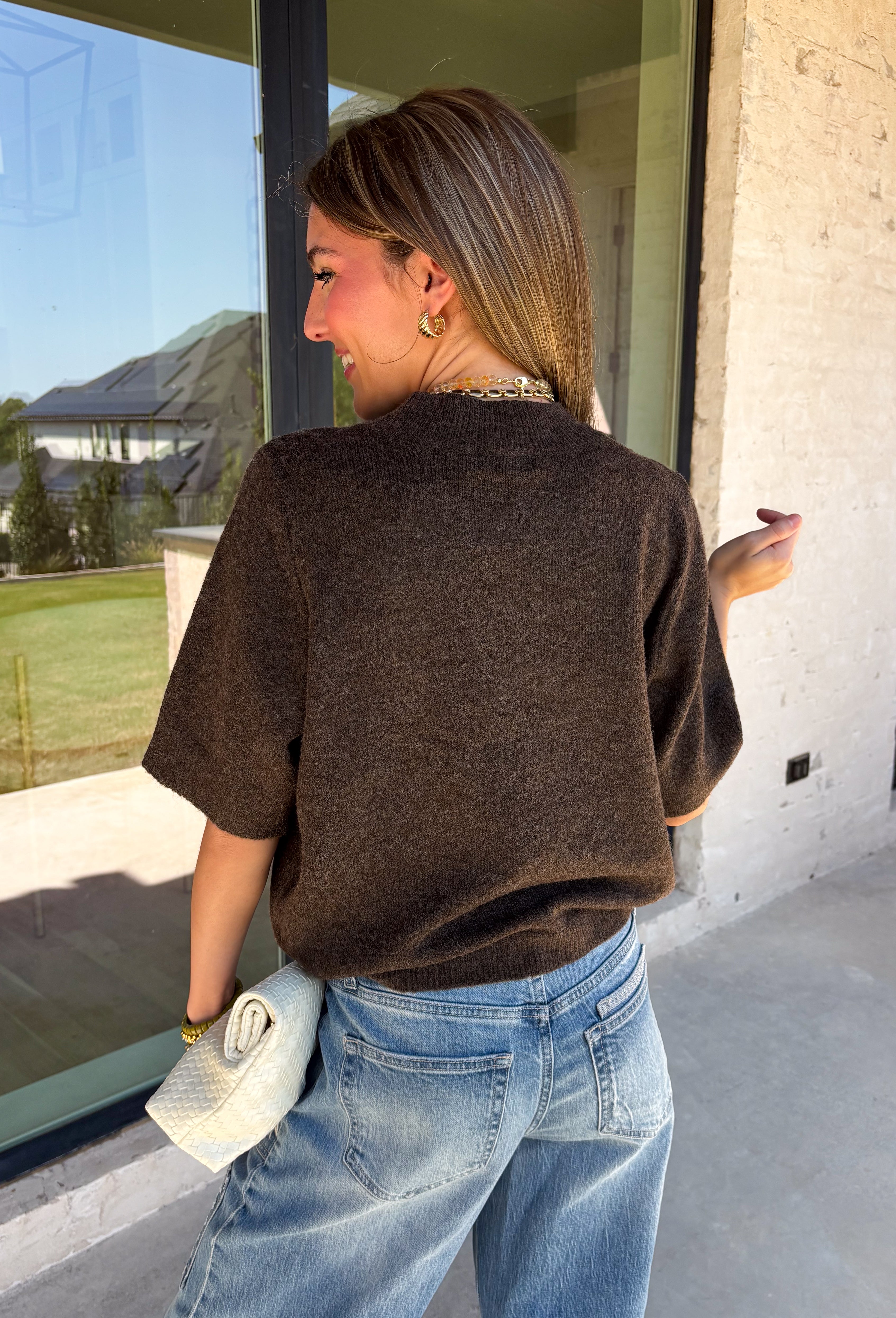 Every fall wardrobe needs a sweater like this! Soft, cozy, and endlessly versatile, this cocoa mock neck short sleeve sweater is the perfect layering piece for the season. The lightweight knit makes it comfortable enough for warmer autumn afternoons while still providing the cozy feel you'll love as temperatures begin to cool. Finished with a classic mock neckline and ribbed detailing, this timeless sweater pairs effortlessly with everything from your favorite denim to tailored trousers.