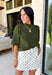 Every fall wardrobe needs a sweater like this! Soft, cozy, and endlessly versatile, this olive mock neck short sleeve sweater is the perfect layering piece for the season. The lightweight knit makes it comfortable enough for warmer autumn afternoons while still providing the cozy feel you'll love as temperatures begin to cool. Finished with a classic mock neckline and ribbed detailing, this timeless sweater pairs effortlessly with everything from your favorite denim to tailored trousers.