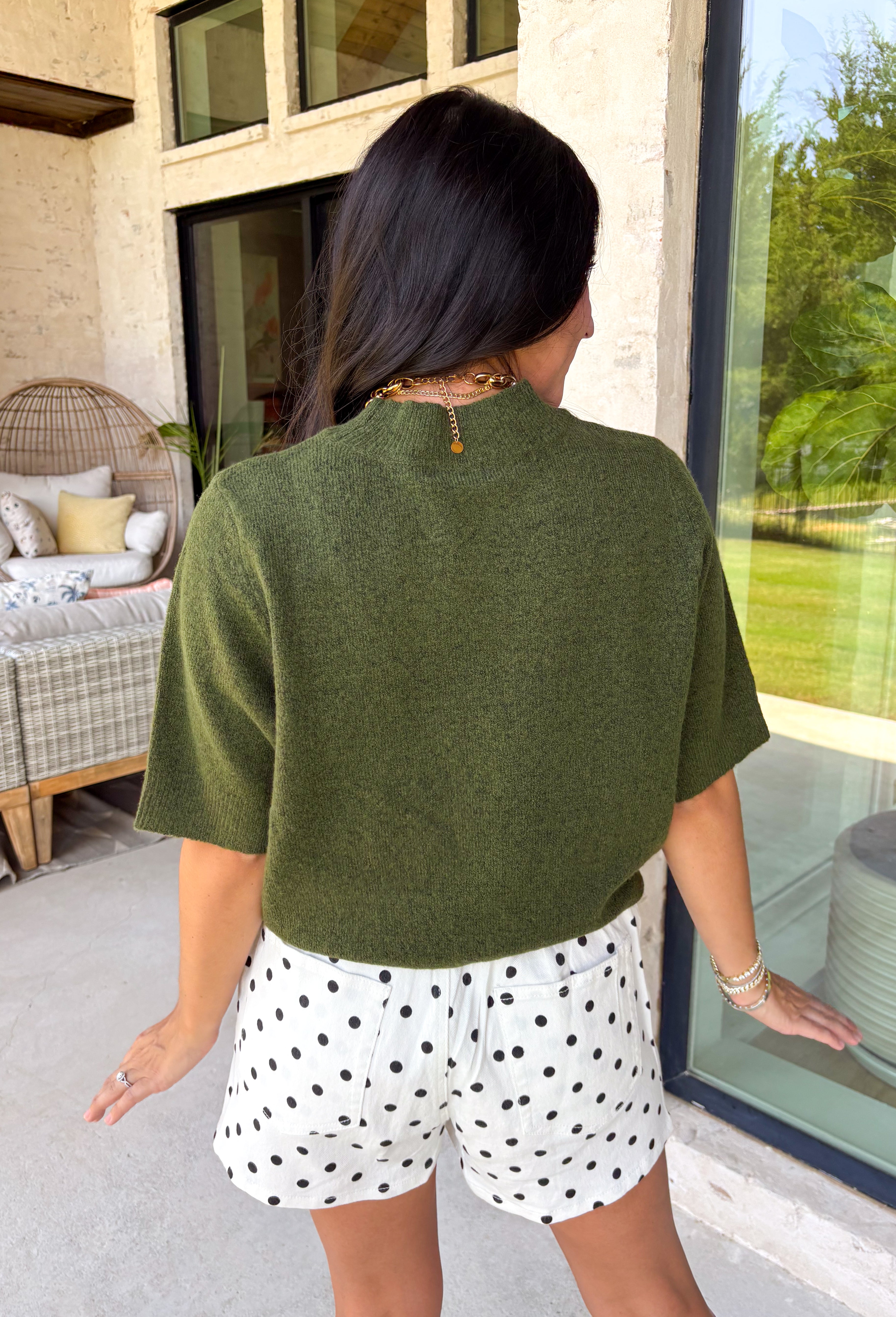 Every fall wardrobe needs a sweater like this! Soft, cozy, and endlessly versatile, this olive mock neck short sleeve sweater is the perfect layering piece for the season. The lightweight knit makes it comfortable enough for warmer autumn afternoons while still providing the cozy feel you'll love as temperatures begin to cool. Finished with a classic mock neckline and ribbed detailing, this timeless sweater pairs effortlessly with everything from your favorite denim to tailored trousers.