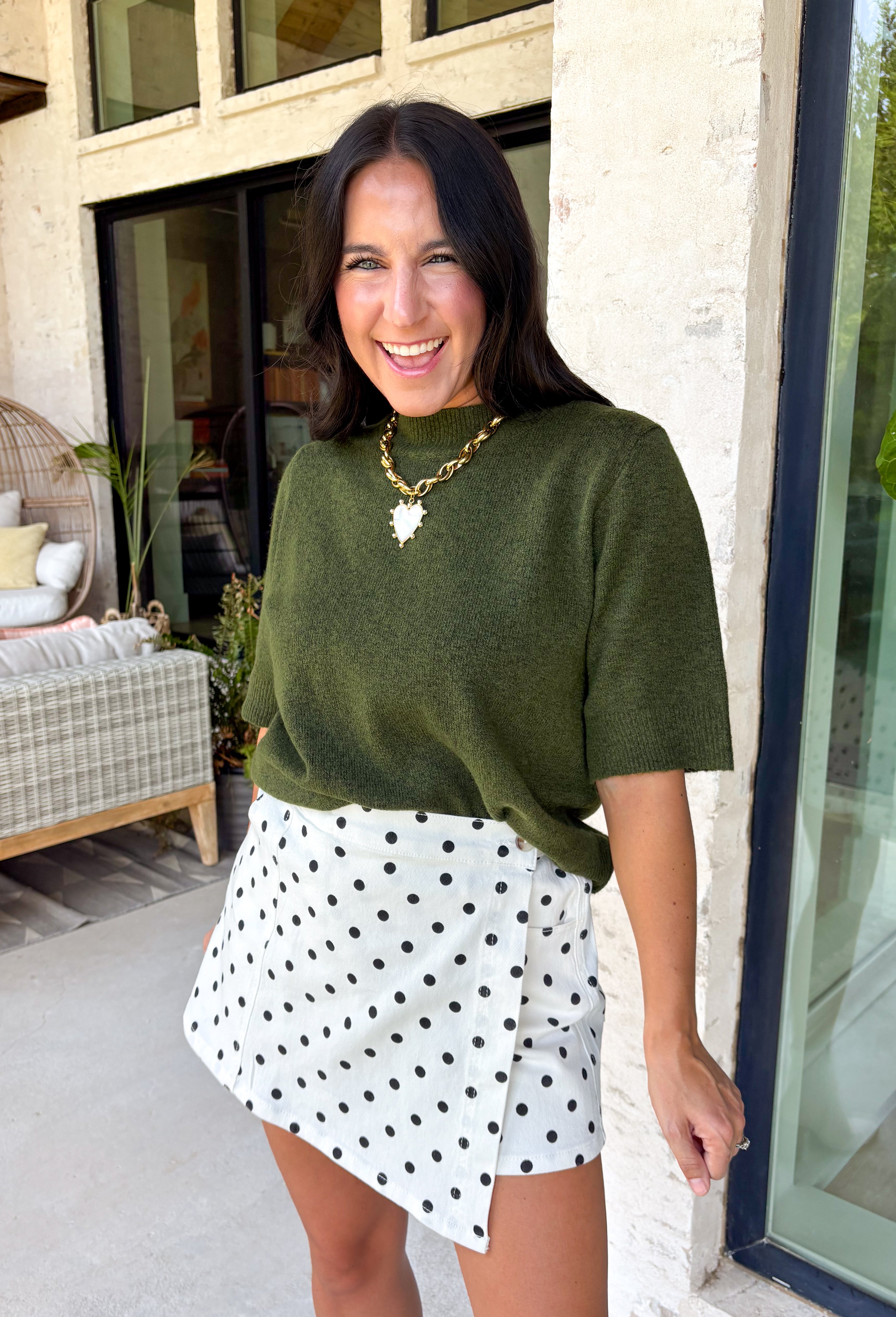 Every fall wardrobe needs a sweater like this! Soft, cozy, and endlessly versatile, this olive mock neck short sleeve sweater is the perfect layering piece for the season. The lightweight knit makes it comfortable enough for warmer autumn afternoons while still providing the cozy feel you'll love as temperatures begin to cool. Finished with a classic mock neckline and ribbed detailing, this timeless sweater pairs effortlessly with everything from your favorite denim to tailored trousers.