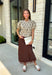 A classic print meets an effortlessly feminine silhouette in this charming knit cardigan! Featuring a soft tan knit with a playful brown polka dot print, this button-down cardigan is finished with sweet puff sleeves for an elevated touch. Whether worn buttoned as a top or layered over your favorite basics, this versatile piece is perfect for everything from office days to coffee dates and weekend outings.